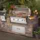 stone wall with built in stainless steel gas grill and burner